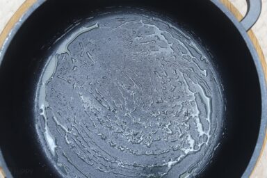 cast iron skillet coated with butter