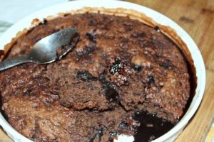Baked chocolate pudding floating on its own sauce