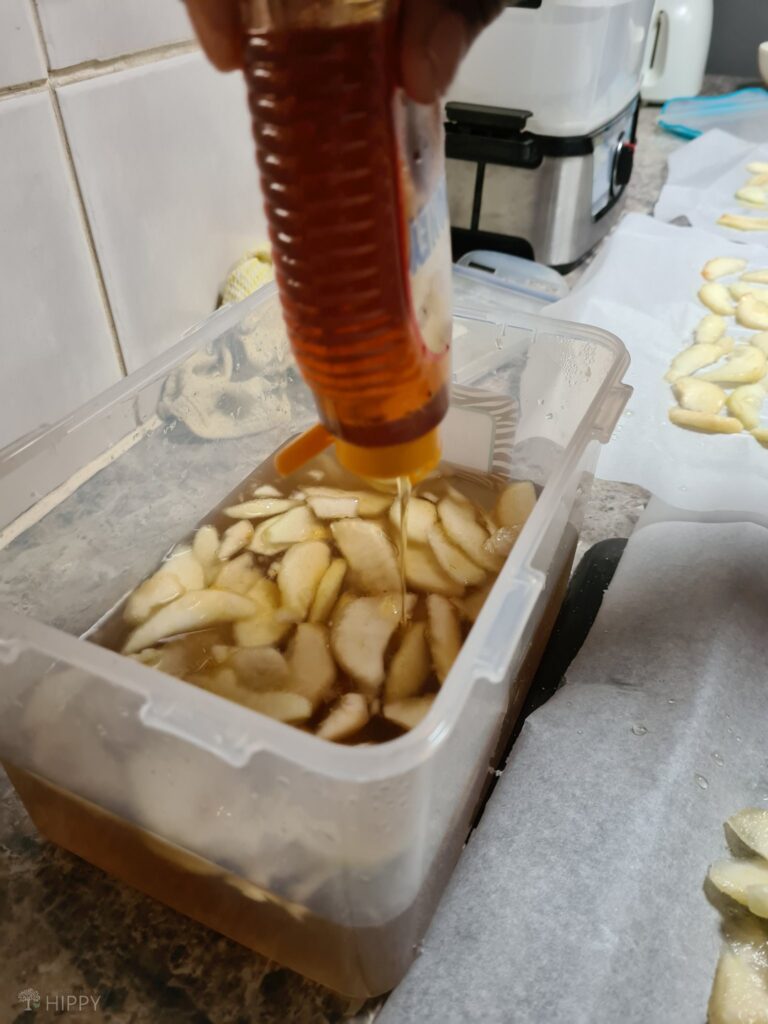 adding honey to pear slices soaked in sugar water