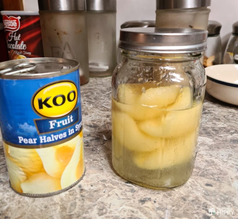 can of commercial canned pears next to jar of homemade canned pears