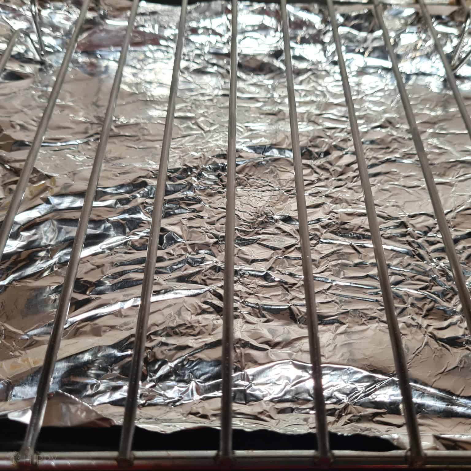 metal rack over aluminum foil in oven