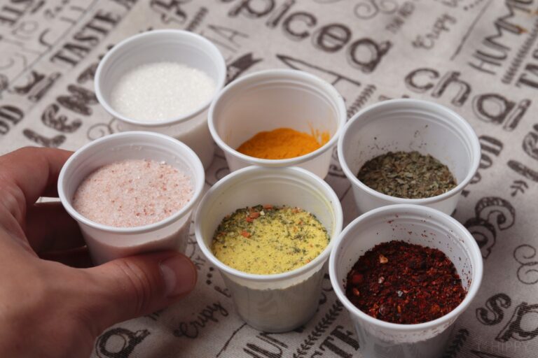 various spices in small plastic cups