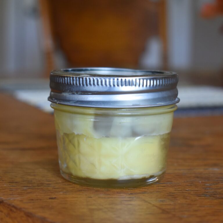 citrusy beard oil in small glass jar