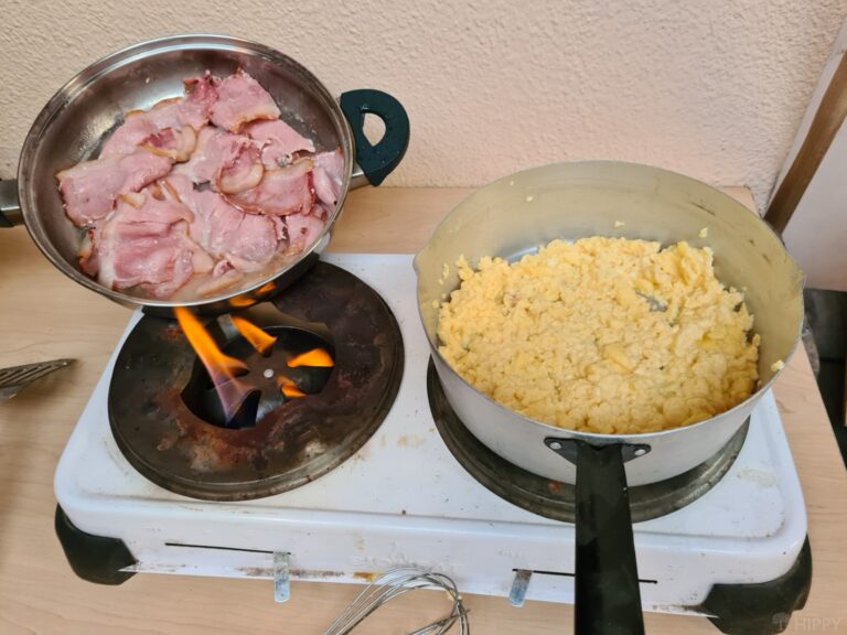 cooking bacon and eggs on a stove