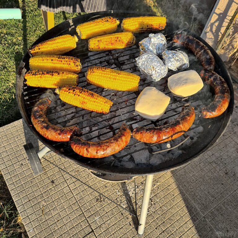 cooking corn sausages potatoes braai bread rolls on barbeque grill