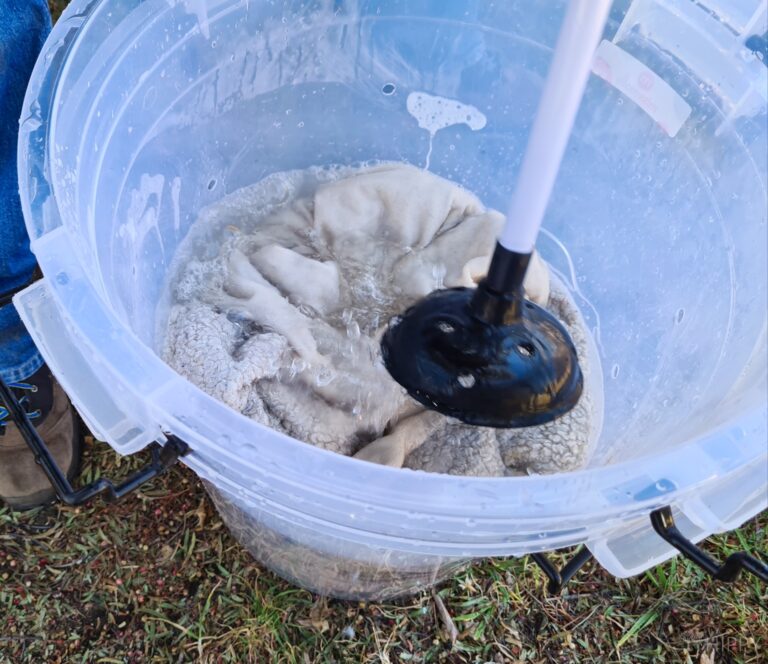 DIY washing machine in action using a plunger