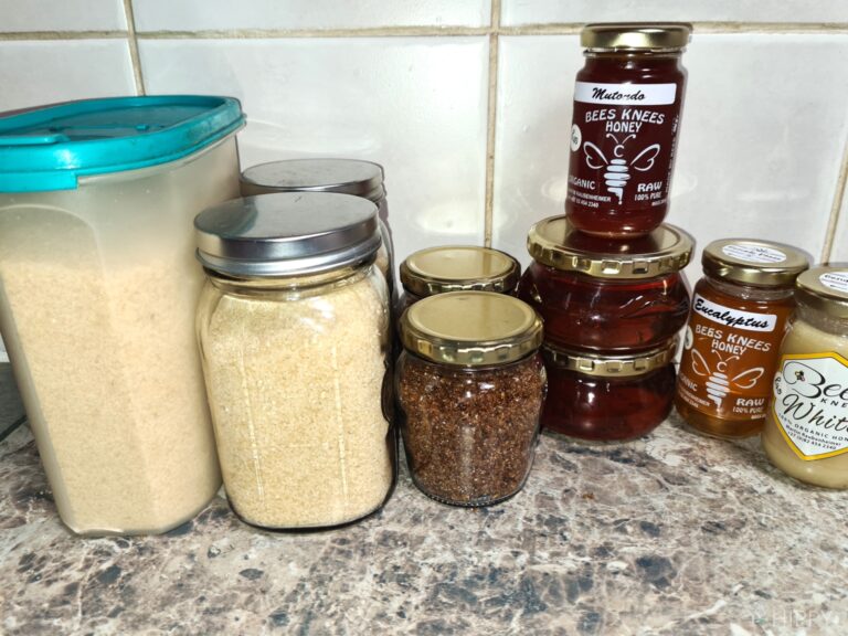 various types of sugar stored in Tupperware and glass jars