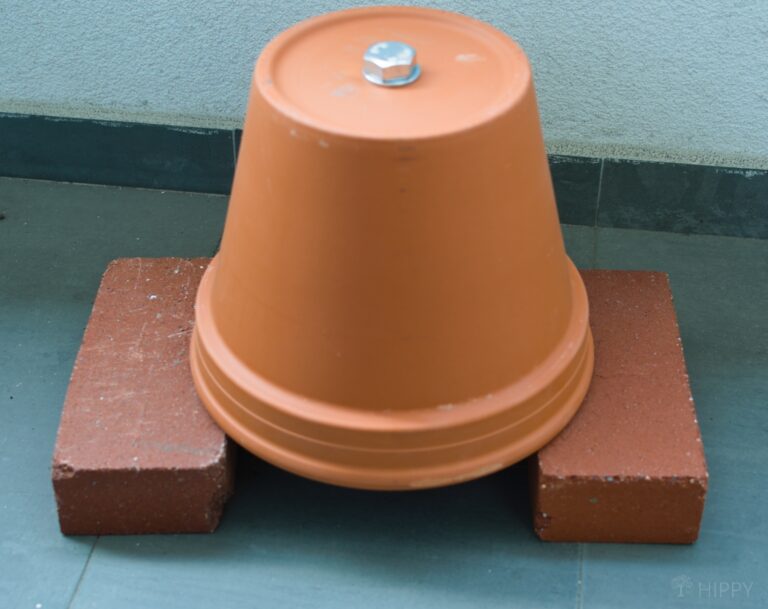 two terracotta pots upside-down over two bricks