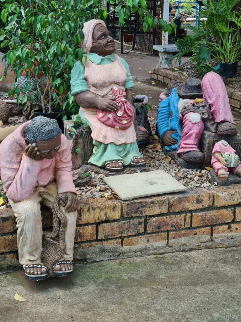 three garden figurines of people