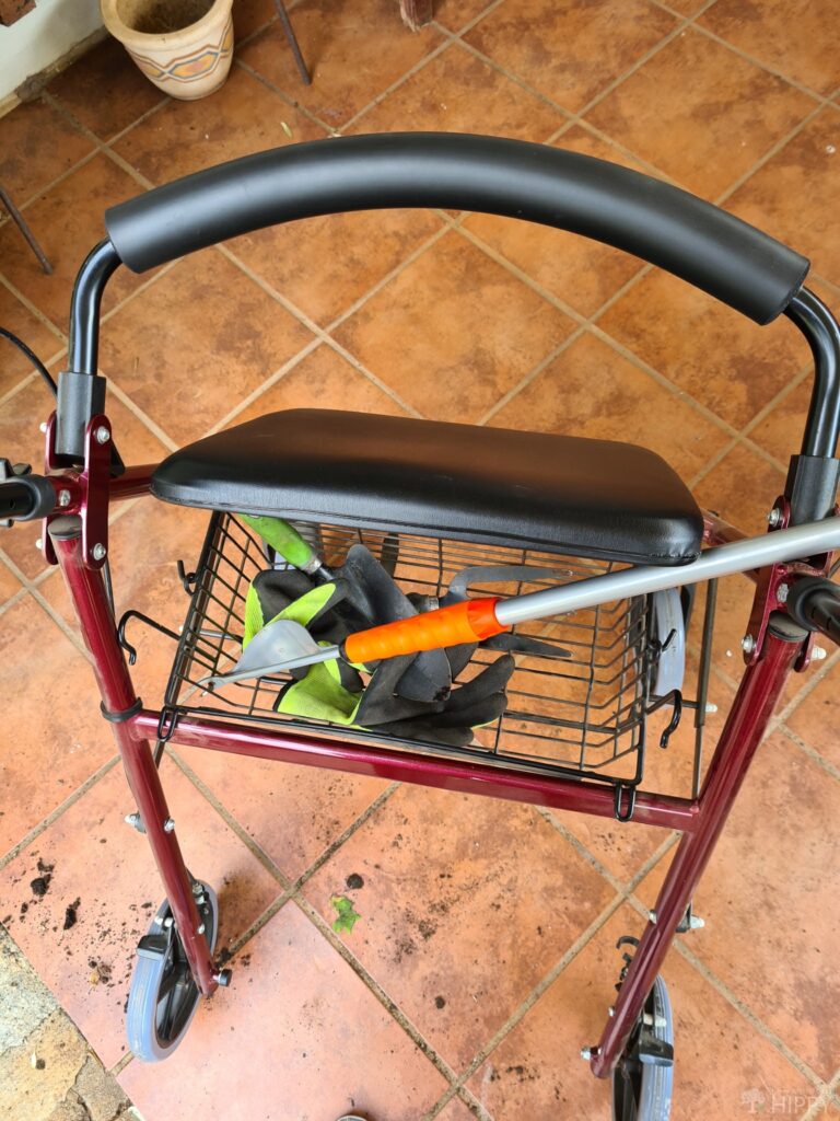 wheelchair basket holding gardening tools