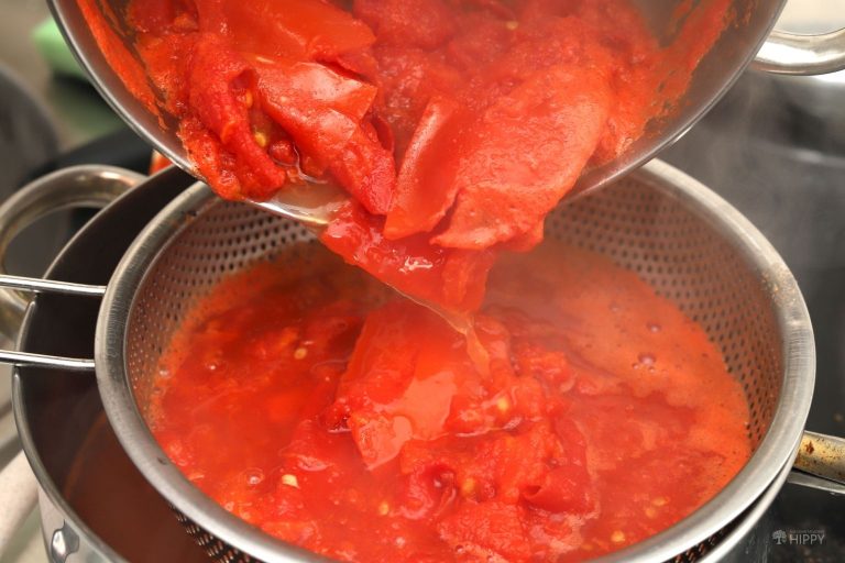 straining boiled tomatoes