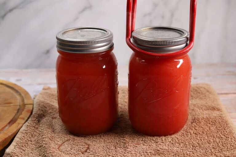setting cans of watermelon jelly to cool