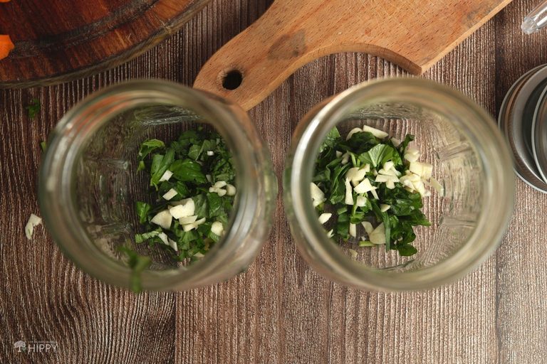 chopped garlic and basil in jars