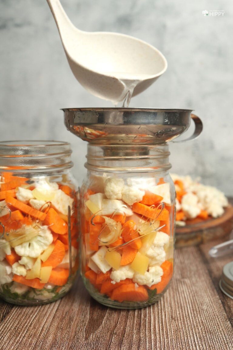 ladling brine to jar of Giardiniera