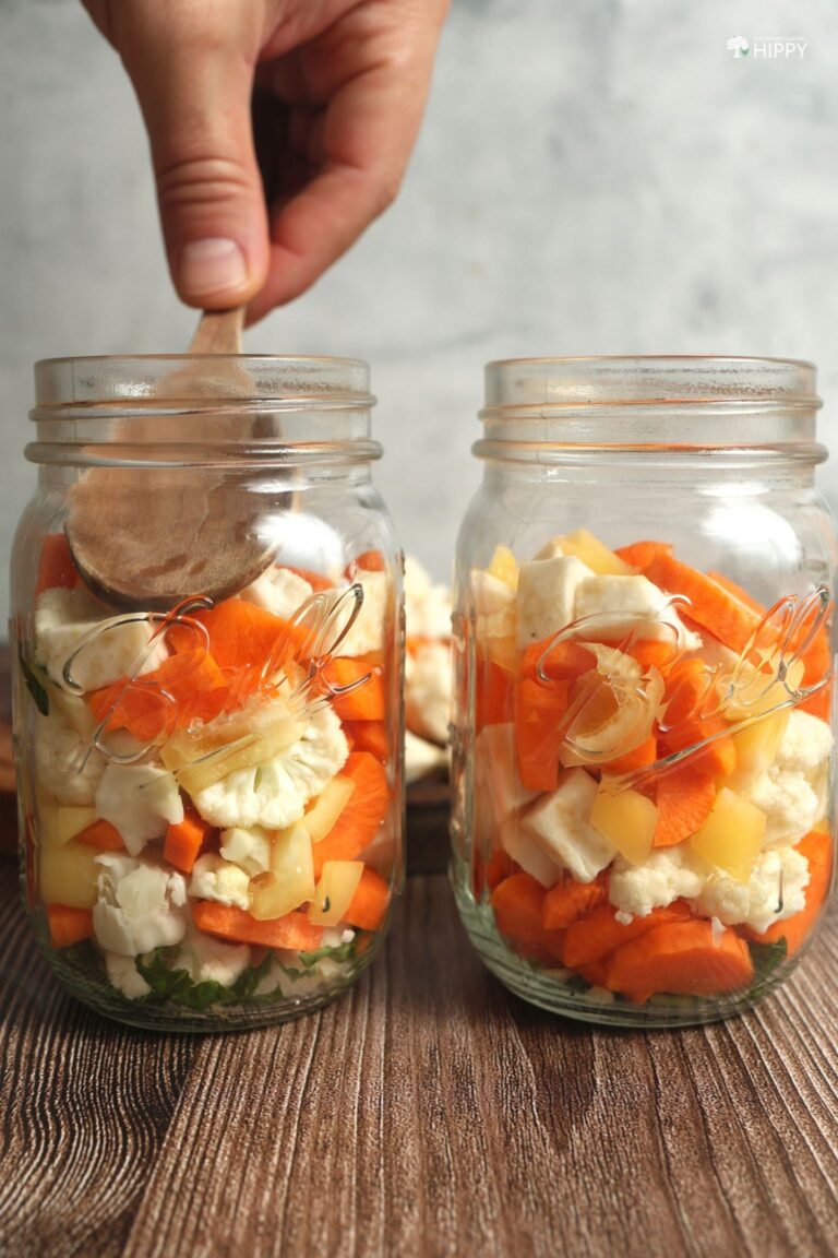 pressing down chopped veggies in jar