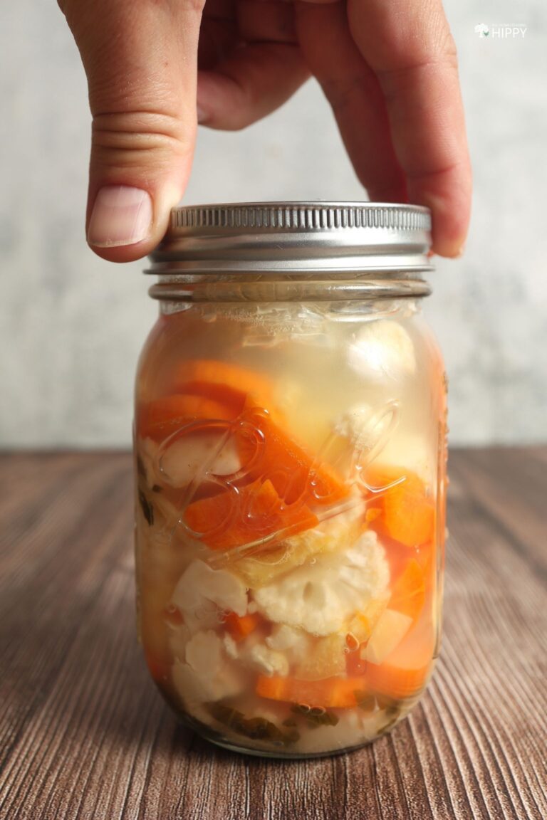 screwing normal lid to jar of fermented giardiniera